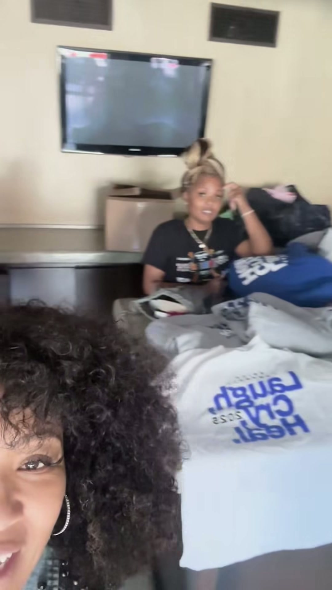 Erica Campbell and the Laugh, Cry, Heal team preparing event merchandise on event day